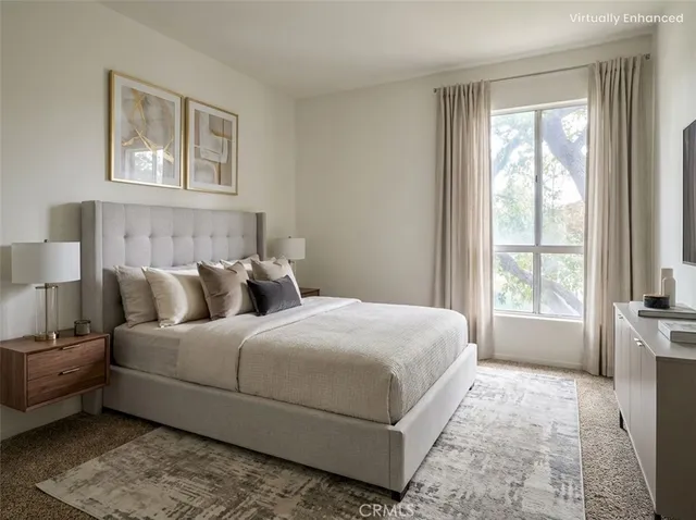 a bedroom with a large bed and a window