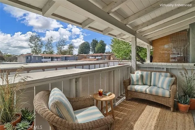 a balcony with outdoor seating and plants