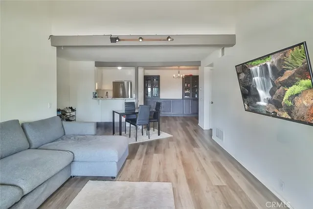 a living room with furniture and wooden floor