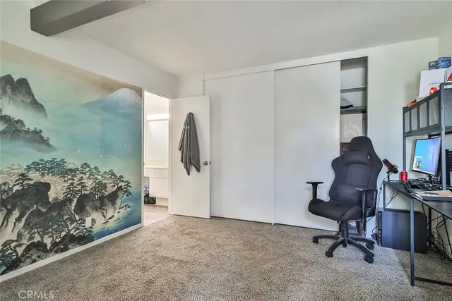 a view of a workspace with furniture and a bedroom