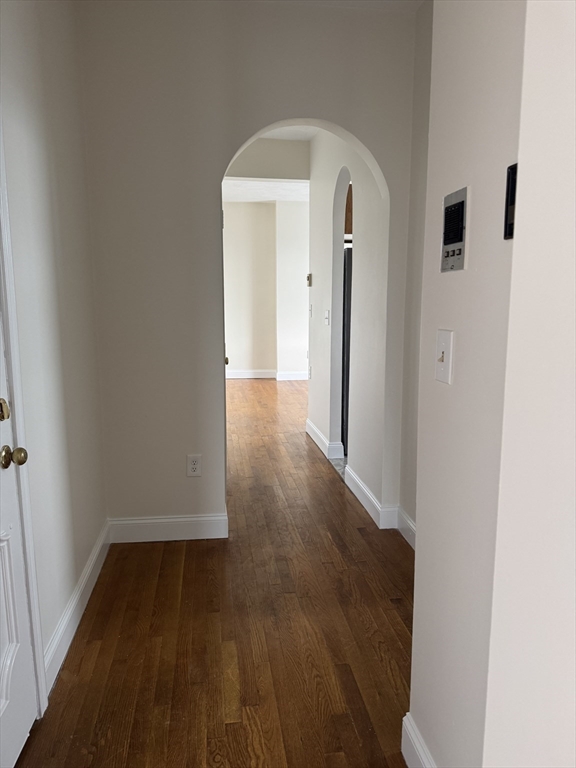 25-31 Maverick Square, Unit 5 Boston, MA 02128 - Photo 20 of 26 an empty room with wooden floor and a window