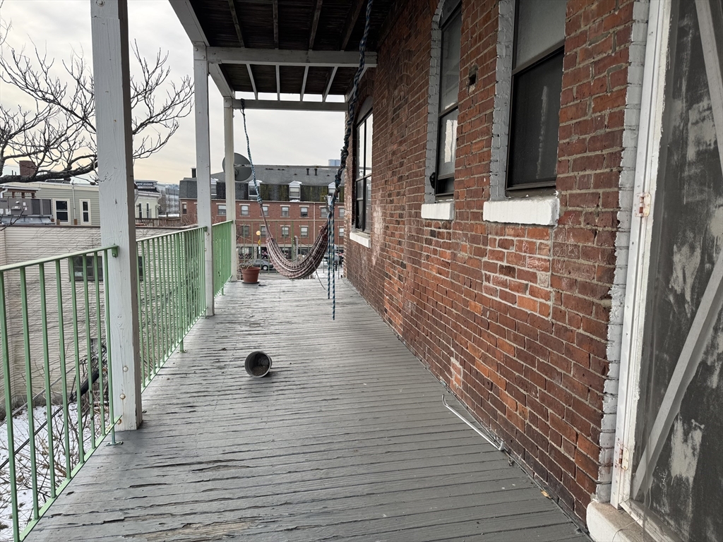 25-31 Maverick Square, Unit 5 Boston, MA 02128 - Photo 25 of 26 a view of a balcony with wooden floor