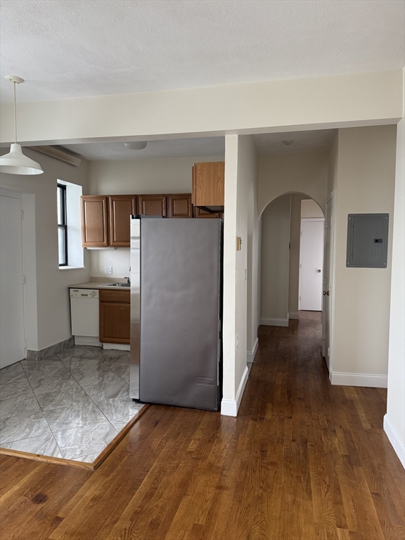 25-31 Maverick Square, Unit 5 Boston, MA 02128 - Photo 6 of 26 an empty room with a kitchen and a sink