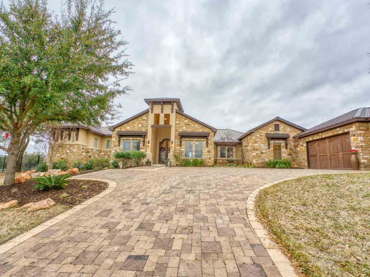 a front view of a house with a yard and trees