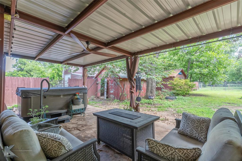 202 East Ross Street Rising Star, TX 76471 - Photo 32 of 40 a backyard of a house with a garden and outdoor seating