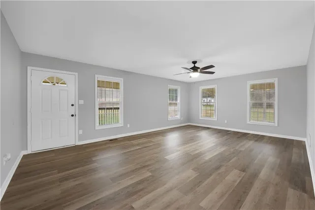 wooden floor in an empty room with a window
