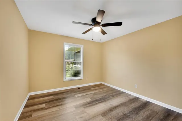 a view of empty room with ceiling fan