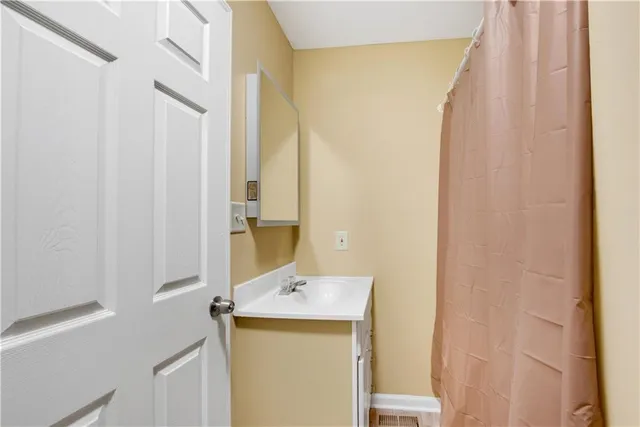 a bathroom with a sink and mirror