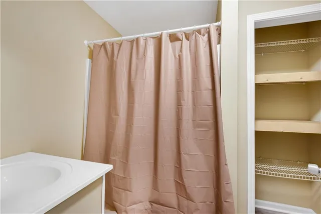 a bathroom with a shower and a sink