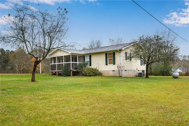 a front view of house with yard and trees
