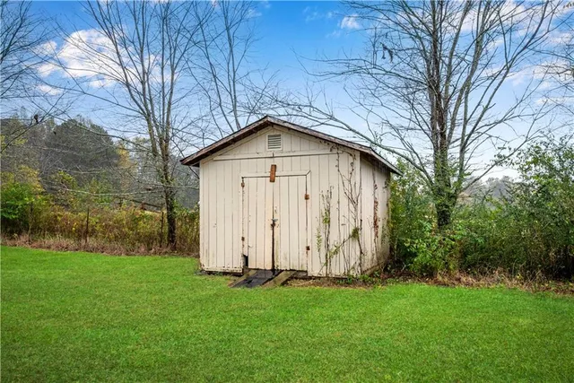 a view of backyard of house with green space
