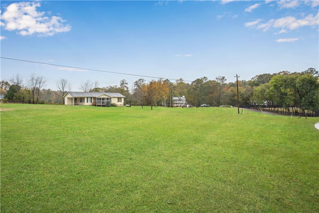 700 Tilley Road Talking Rock, GA 30175 - Photo 6 of 32 a view of a field with an trees in the background