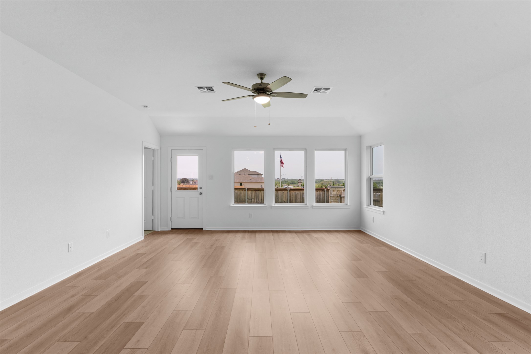 13701 Tucker Hedge Pass Elgin, TX 78621 - Photo 12 of 21 Spacious room featuring light wood-finish flooring, white walls, and a ceiling fan