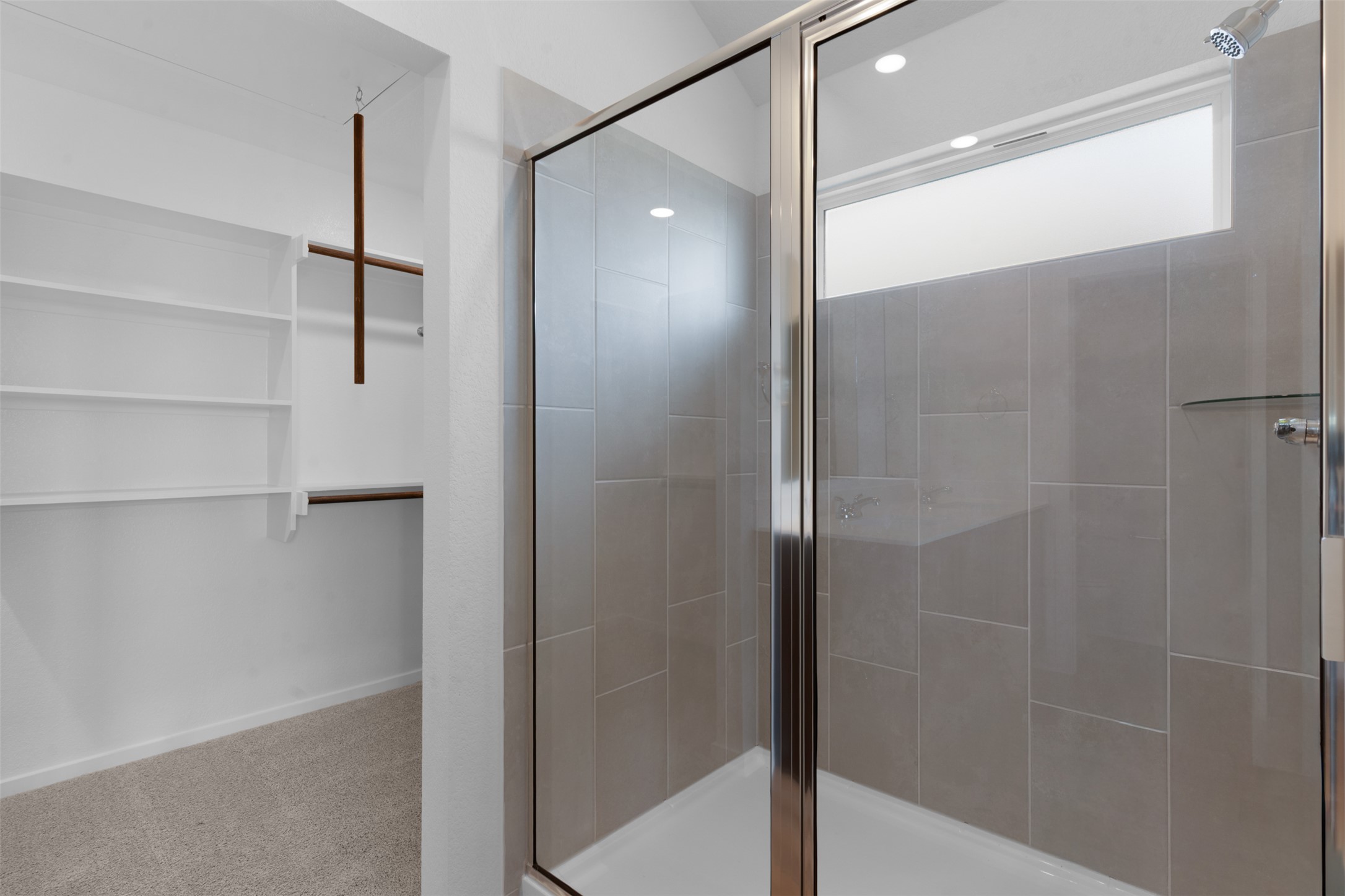 13701 Tucker Hedge Pass Elgin, TX 78621 - Photo 15 of 21 Walk-in shower with clear glass enclosure and light gray tile surround