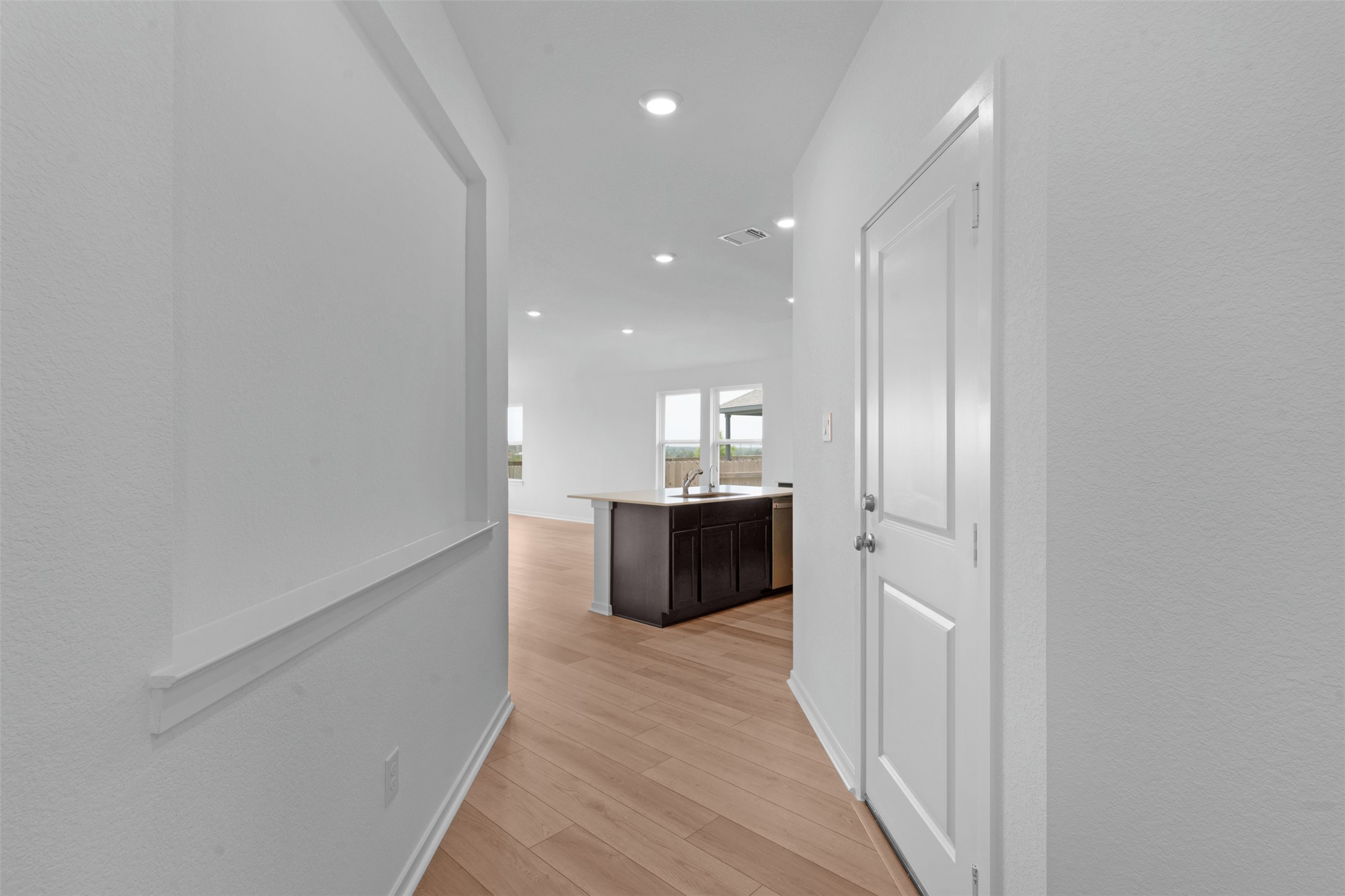 13701 Tucker Hedge Pass Elgin, TX 78621 - Photo 6 of 21 Entryway with light wood-finish flooring, recessed lighting, and a paneled door
