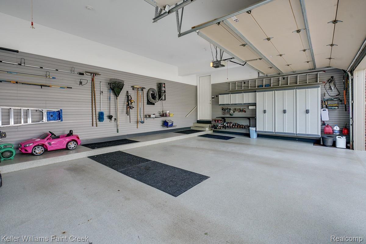 4902 Crestone Way Rochester, MI 48306 - Photo 67 of 70 Expansive, three car garage with Epoxy floors and well thought out storage options.