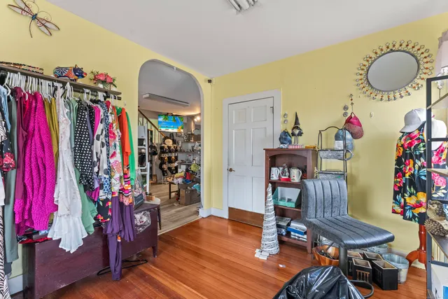 a view of a dining room with furniture chandeliers and wooden floor