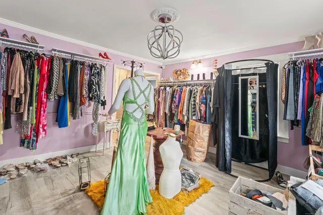 a view of walk in closet with clothes and shoes