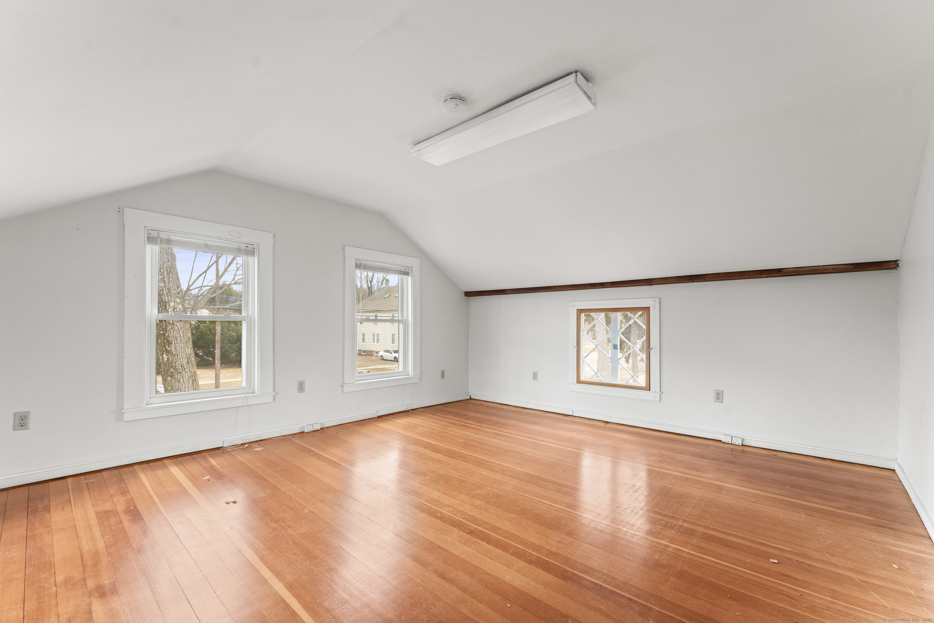 287 Hazard Avenue Enfield, CT 06082 - Photo 20 of 28 an empty room with wooden floor and windows