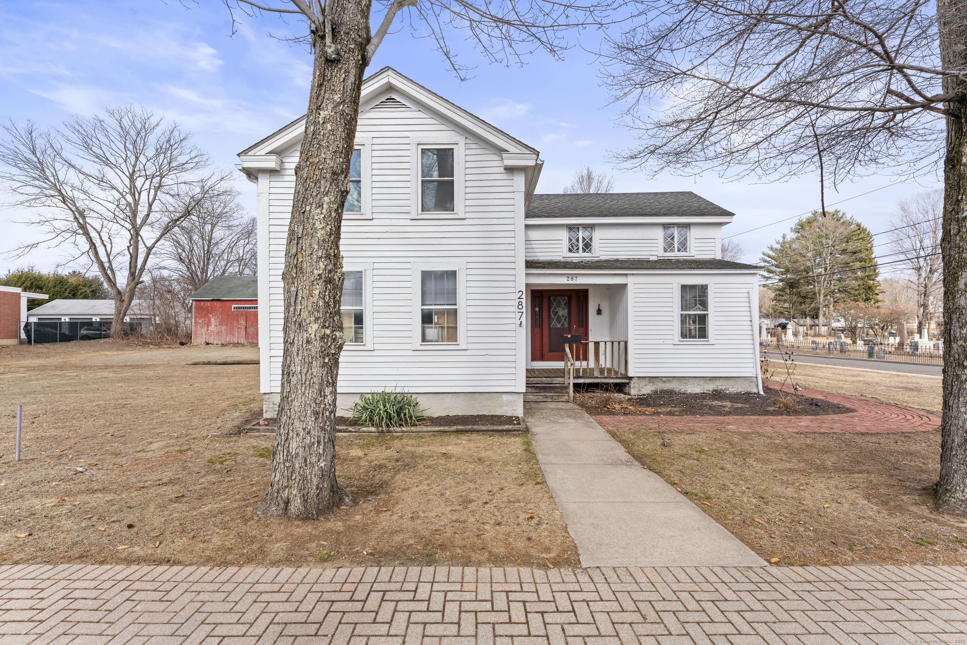 287 Hazard Avenue Enfield, CT 06082 - Photo 5 of 28 a view of a white house with a large tree