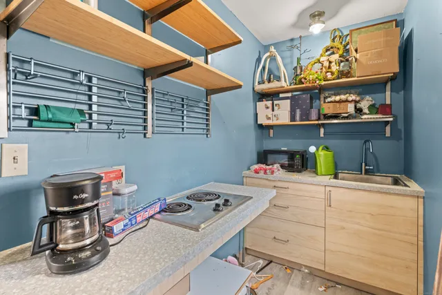 a utility room with dryer washer and a view of living room