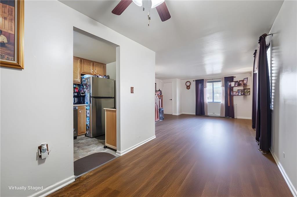 7148 Vann Road Pittsburgh, PA 15206 - Photo 10 of 36 a view of a hallway with wooden floor and a refrigerator
