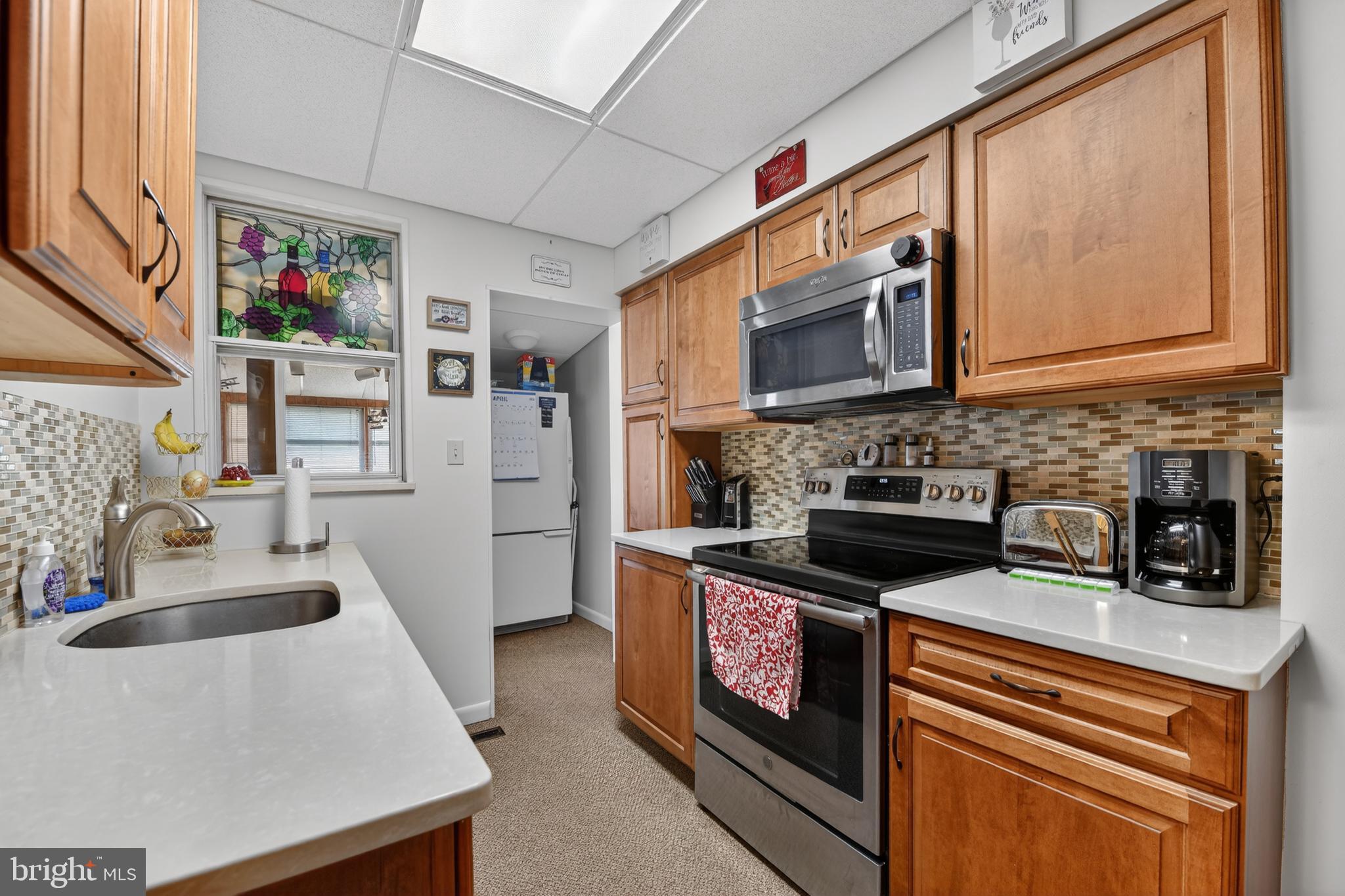 397 Pine Street Reading, PA 19611 - Photo 12 of 42 a kitchen with stainless steel appliances granite countertop a stove a sink and a microwave