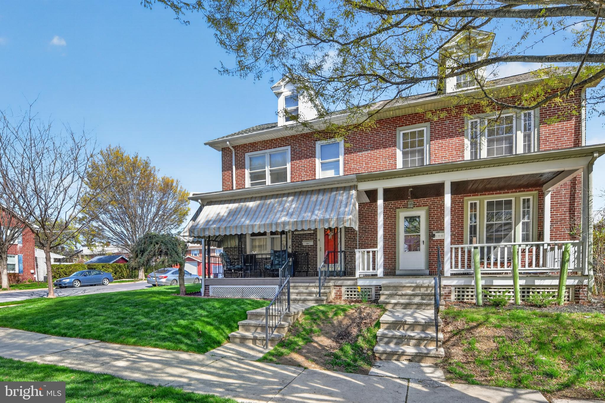 397 Pine Street Reading, PA 19611 - Photo 5 of 42 front view of a brick house with a yard