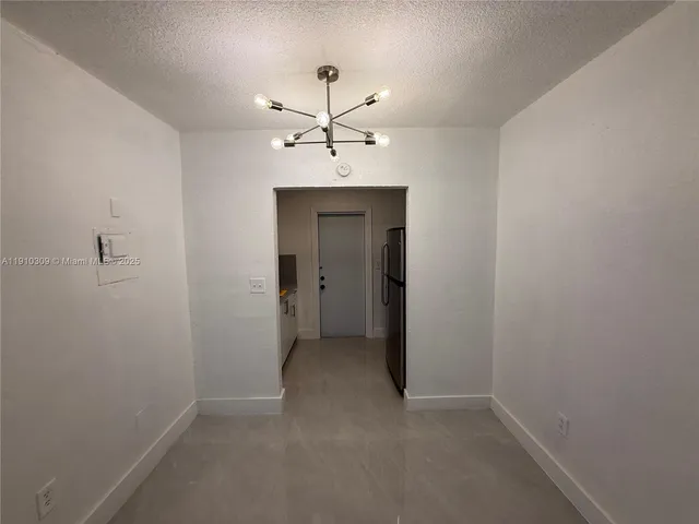 an empty room with a ceiling fan and a bathroom