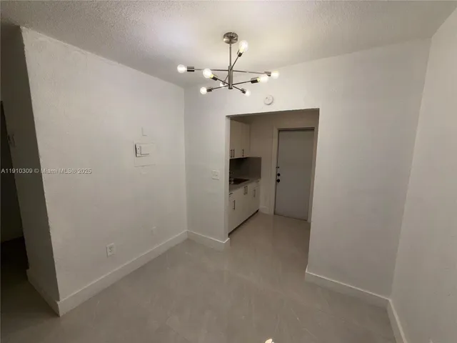a view of a refrigerator in kitchen and wooden floor