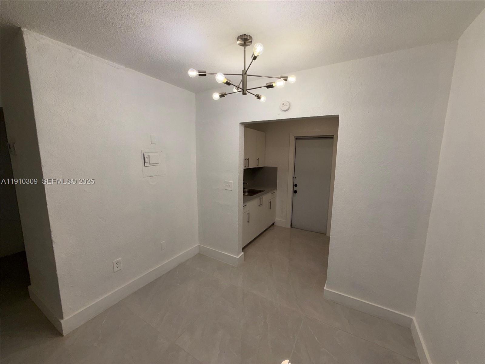 1251 Northwest 61st Street, Unit 5 Miami, FL 33142 - Photo 14 of 15 an empty room with a ceiling fan and a bathroom