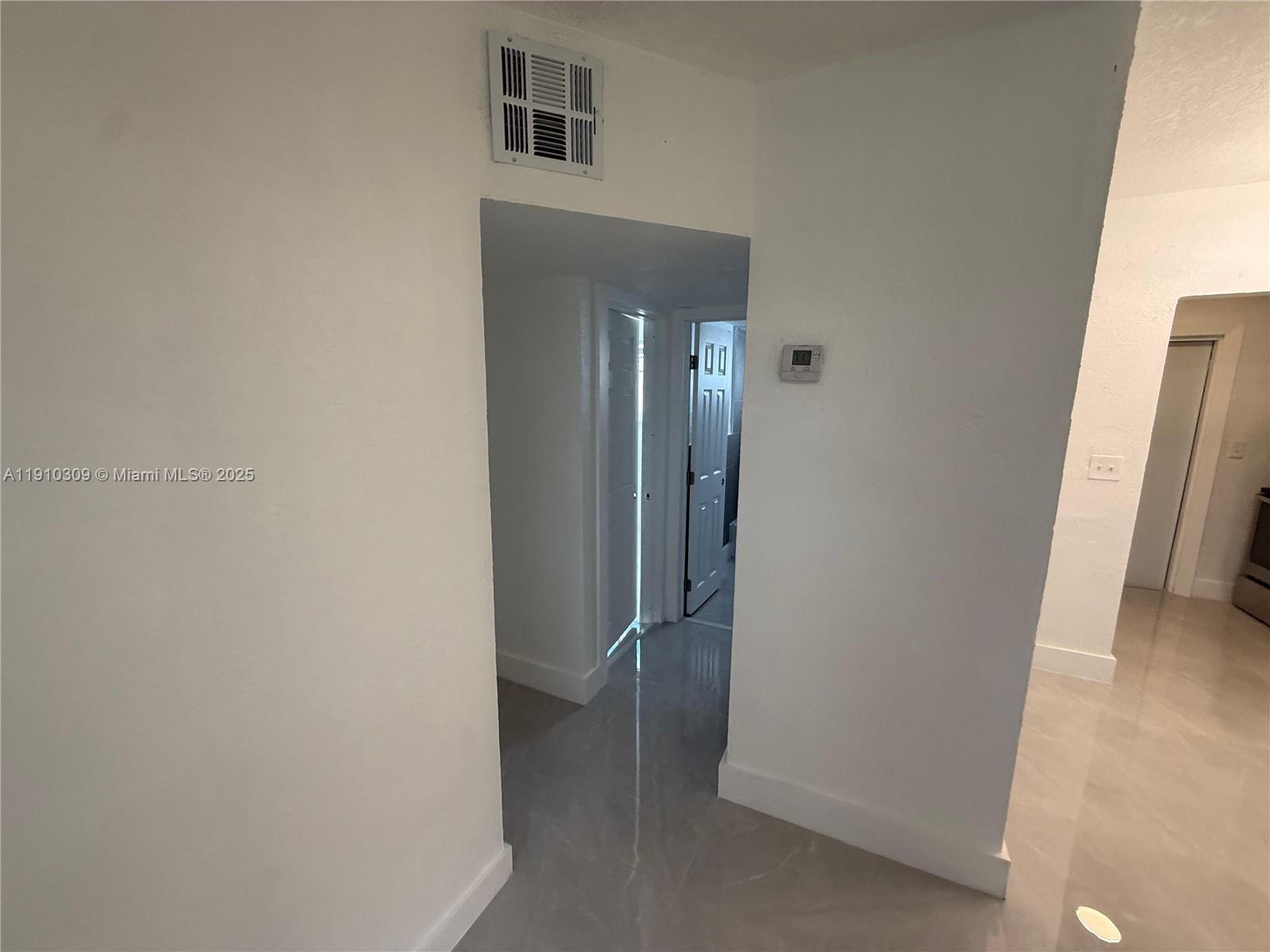 1251 Northwest 61st Street, Unit 5 Miami, FL 33142 - Photo 3 of 15 an empty room with windows