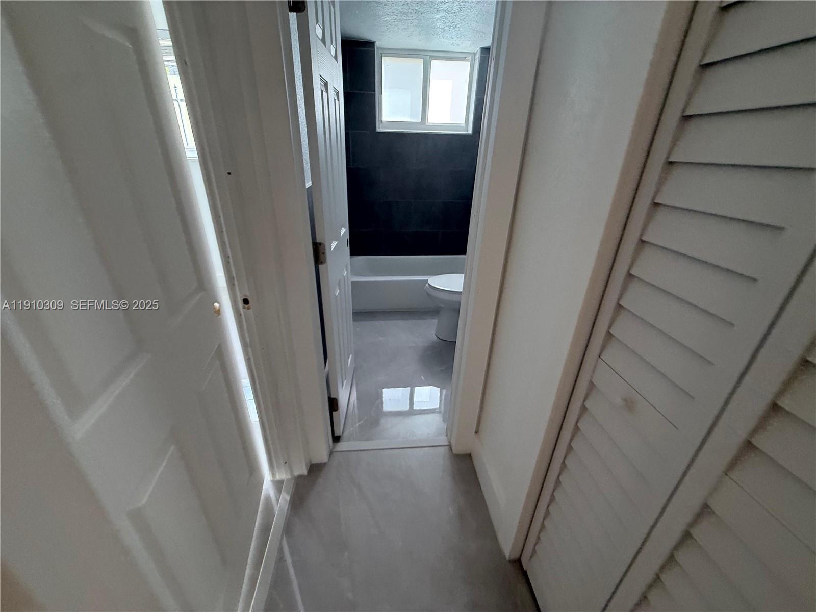 1251 Northwest 61st Street, Unit 5 Miami, FL 33142 - Photo 6 of 15 a view of a hallway