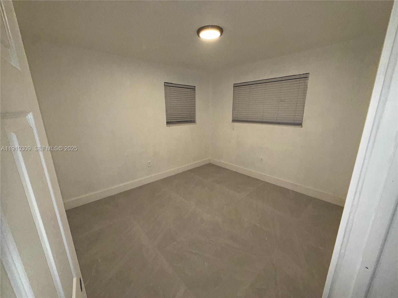 1251 Northwest 61st Street, Unit 5 Miami, FL 33142 - Photo 10 of 15 an empty room with a hallway