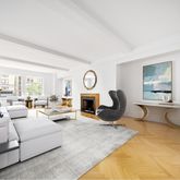 a living room with furniture a large window and potted plant