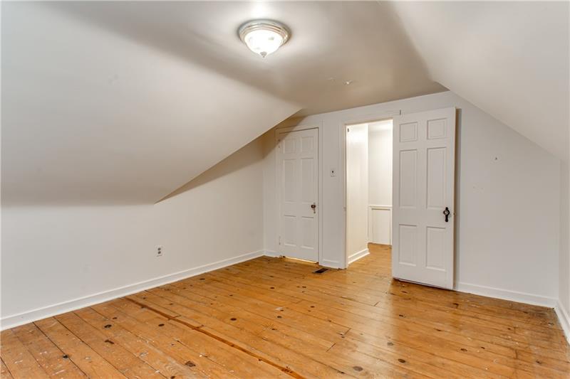919 Glenfield Road Sewickley, PA 15143 - Photo 17 of 24 Upstairs bedroom number 1 with a closet and window and beautiful flooring.