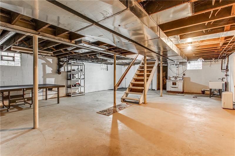 919 Glenfield Road Sewickley, PA 15143 - Photo 21 of 24 The massive basement is clean and bright. There is also a door leading outside.