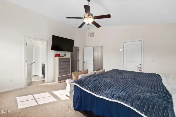 a living room with a bed furniture and a flat screen tv