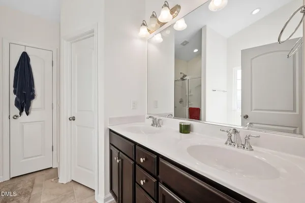 a bathroom with a double vanity sink and a mirror