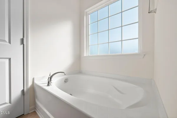 a white bath tub sitting next to a window