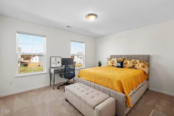 a bedroom with a bed and furniture