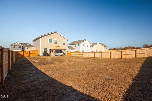 a view of residential houses with outdoor space and trees