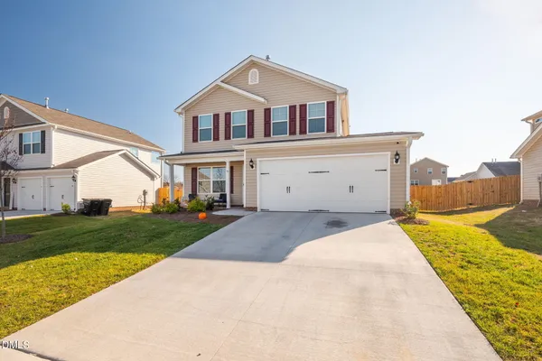 a front view of a house with a yard
