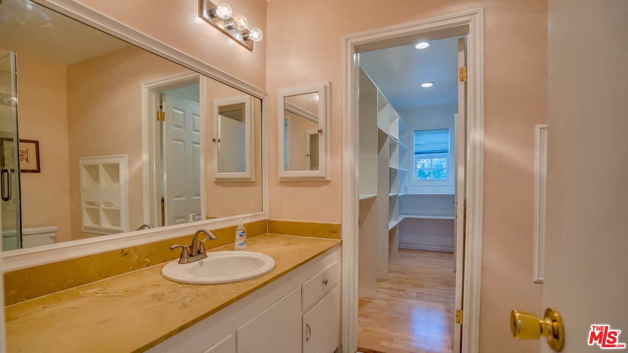 9631 Crystal View Drive Tujunga, CA 91042 - Photo 12 of 57 a bathroom with a granite countertop sink and a mirror