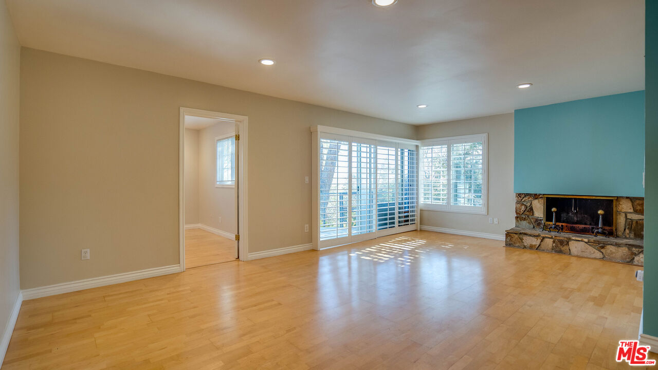 9631 Crystal View Drive Tujunga, CA 91042 - Photo 23 of 57 a view of an empty room with a fireplace and a window