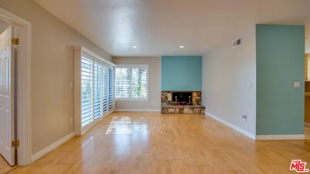 a view of a room with furniture wooden floor and windows