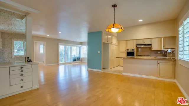 a kitchen with kitchen island granite countertop a sink stove and refrigerator