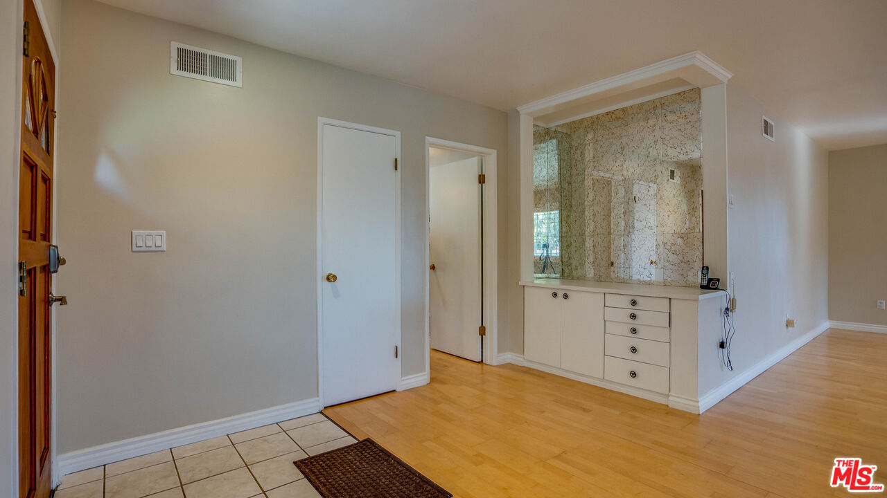 9631 Crystal View Drive Tujunga, CA 91042 - Photo 32 of 57 a room with white cabinets and wooden floor