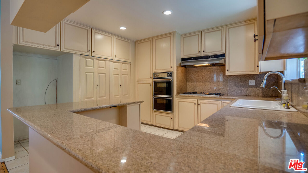 9631 Crystal View Drive Tujunga, CA 91042 - Photo 34 of 57 a kitchen with granite countertop a sink stainless steel appliances and cabinets