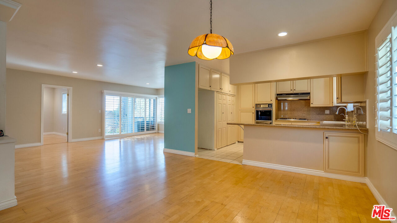 9631 Crystal View Drive Tujunga, CA 91042 - Photo 39 of 57 a large kitchen with stainless steel appliances granite countertop a stove a sink a refrigerator and a view of living room
